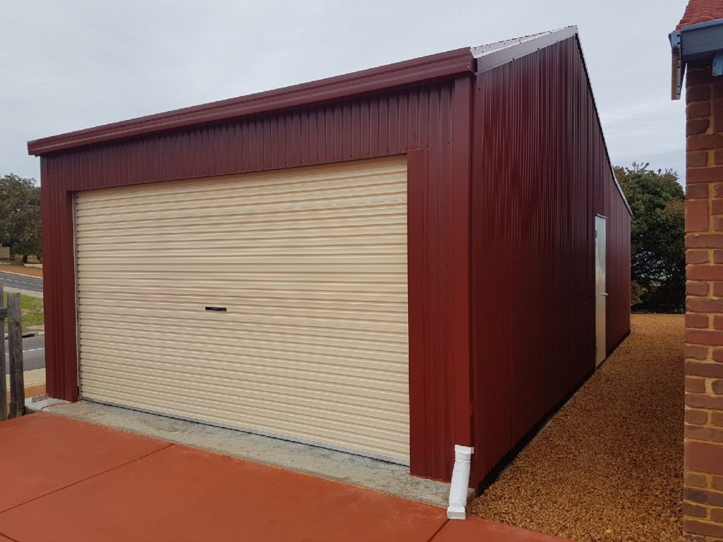 Purpose built singe car garage with red Colorbond exterior.