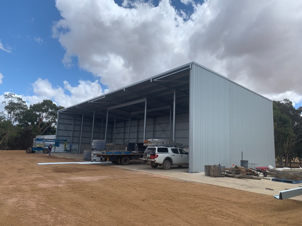Large grain storage shed with machinery storage.